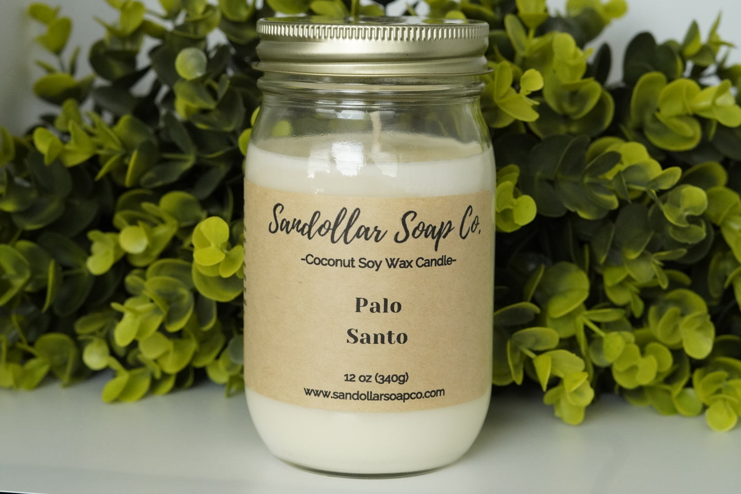 A 12 oz coconut soy wax candle in a mason jar that includes a gold lid. Made with a cotton wick and scented "Palo Santo." Aromatic patchouli has a distinctive, warm, and earthy aroma