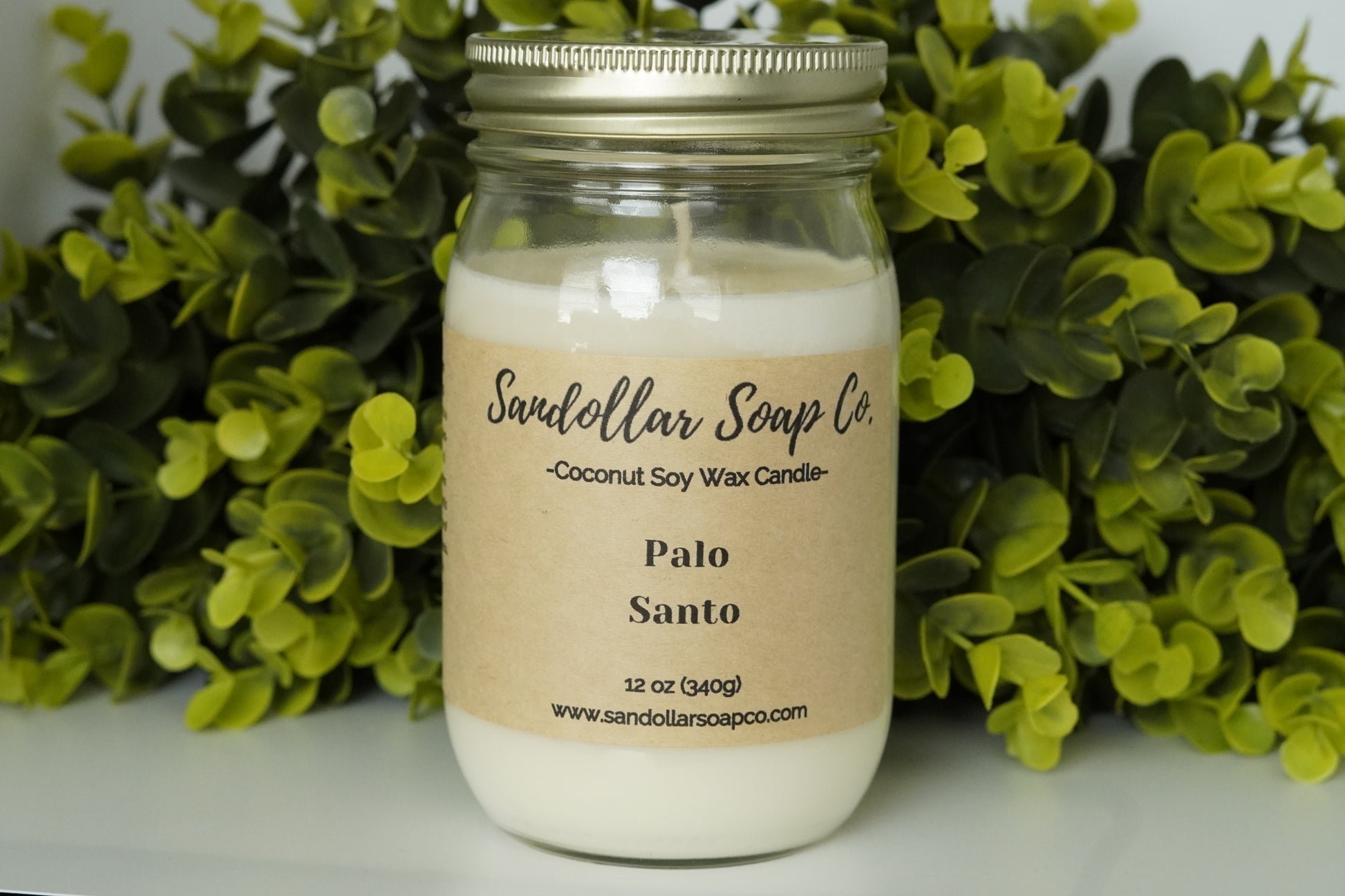A 12 oz coconut soy wax candle in a mason jar that includes a gold lid. Made with a cotton wick and scented "Palo Santo." Aromatic patchouli has a distinctive, warm, and earthy aroma