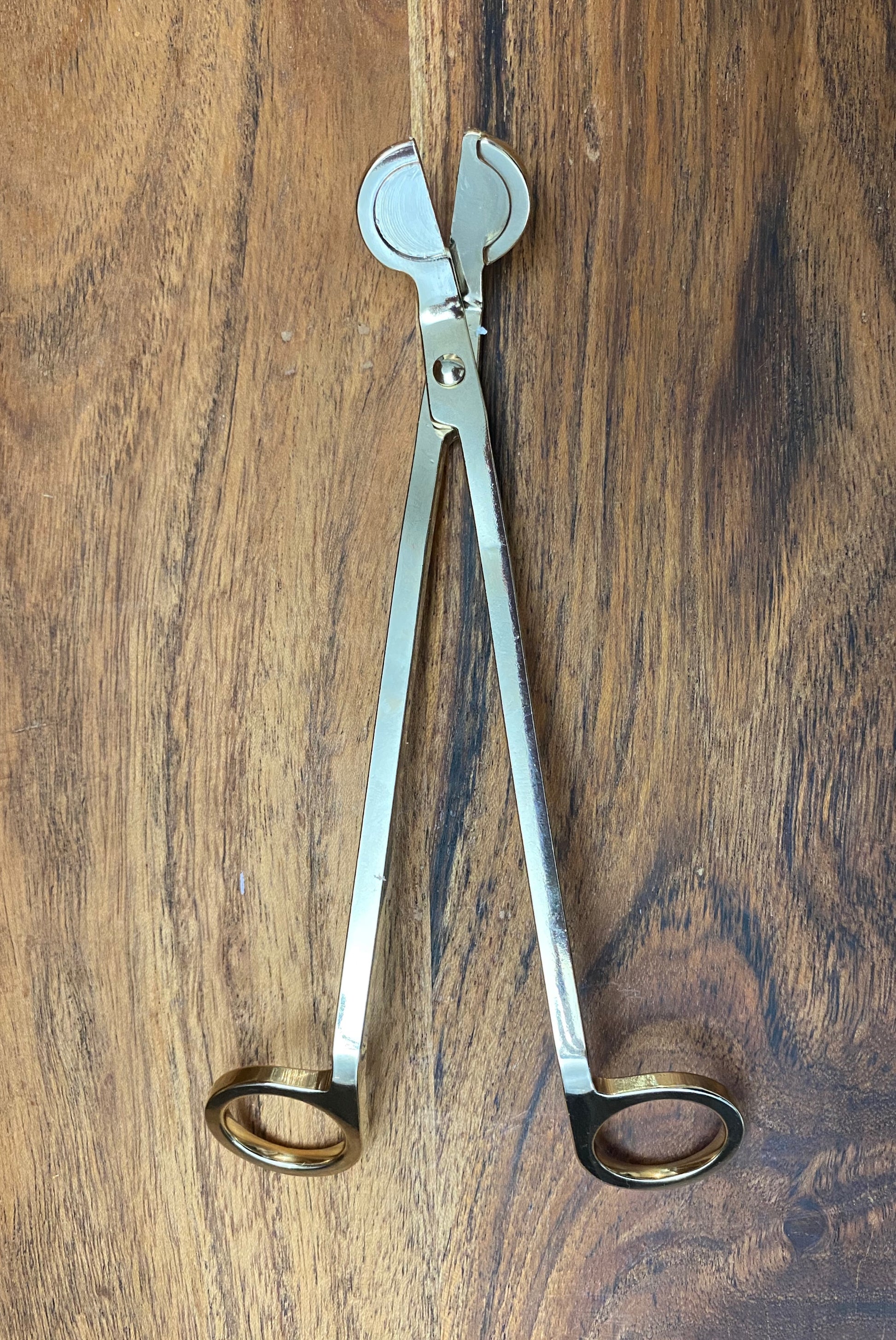 A gold wick trimmer.