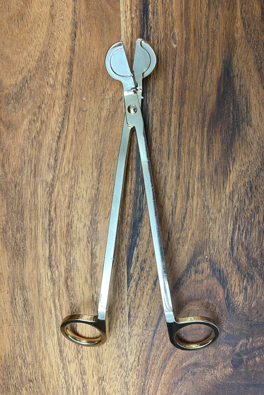 A gold wick trimmer.