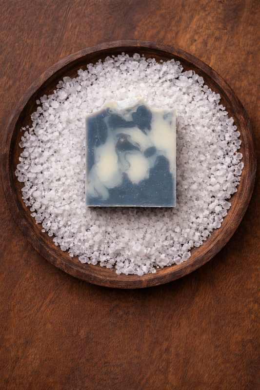 picture of a bar of soap over a bed of salt in a wooden bowl