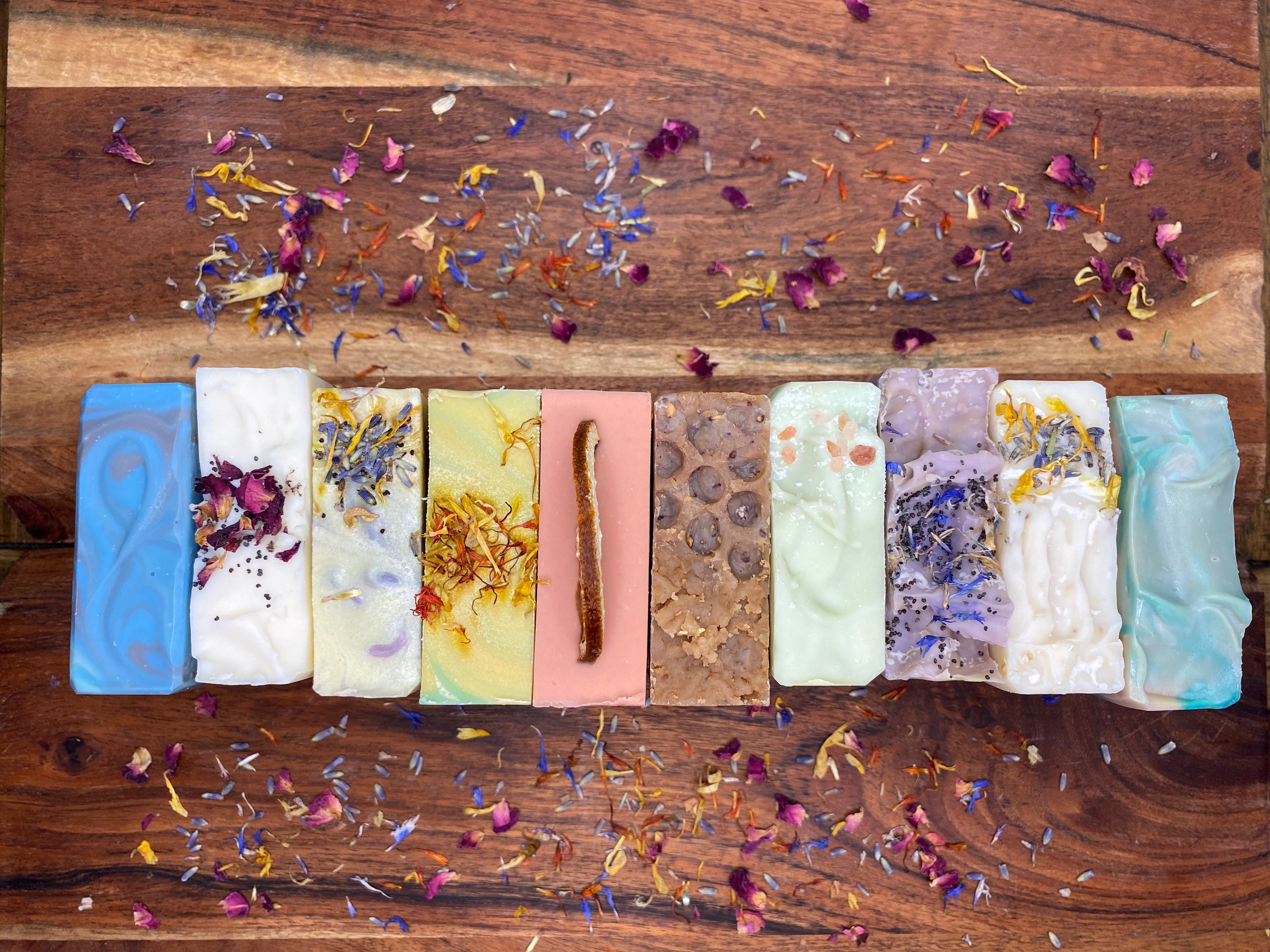 over head shot of soap tops with Botanicals surrounding them